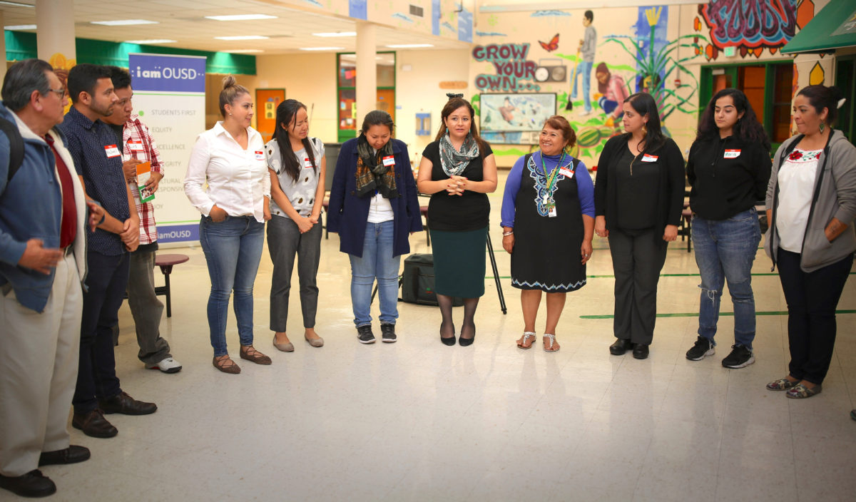 Photo of Raquel Jimenez leading a community discussion as part of Oakland Unified School District’s Latino Student Achievement Listening Campaign in November 2017.