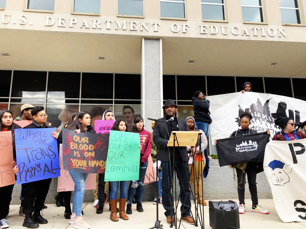 A photo of youth activists rallying on the steps of the U.S. Department of Education offices in Washington, DC, during the End War on Youth Day National Youth Action for Police Free Schools on December 4, 2018 organized by the Alliance for Educational Justice and the Advancement Project.